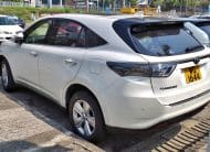 White Toyota Harrier SUV parked in a parking lot, rear three-quarter view with license plate WG 1644.