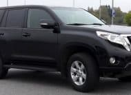 Black Toyota SUV parked in a lot, front-right three-quarter view.