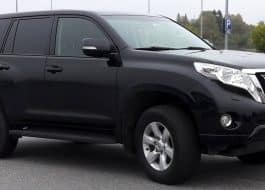 Black Toyota SUV parked in a lot, front-right three-quarter view.