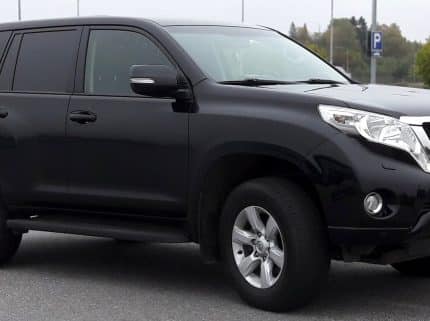 Black Toyota SUV parked in a lot, front-right three-quarter view.